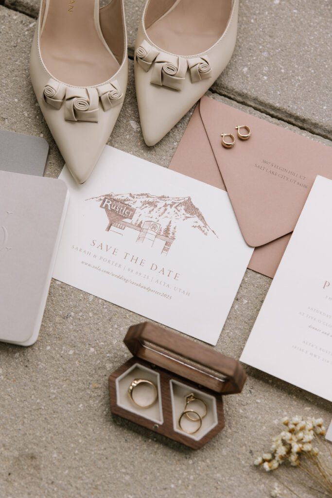 Wedding details with invitation, rings and shoes.
