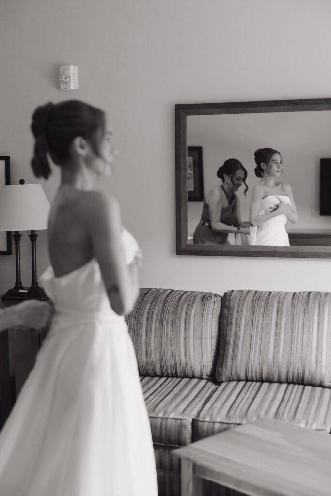 black and white photo of bride getting ready in hotel room
