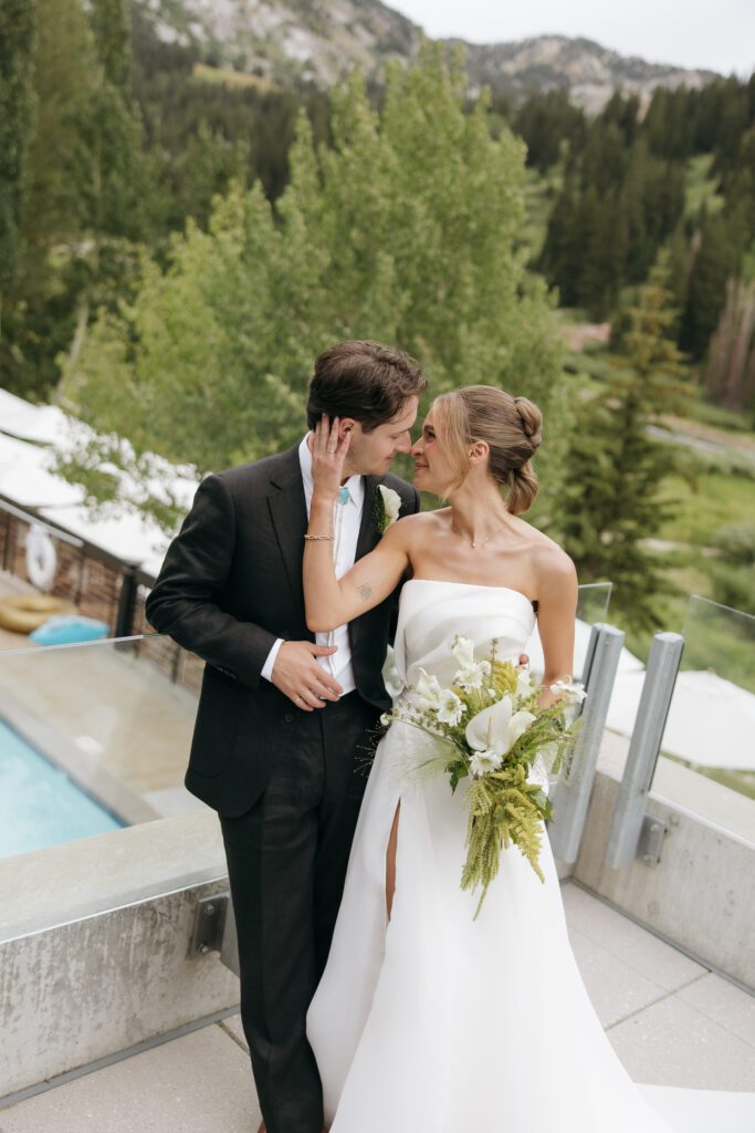 bride and groom embracing on balcony