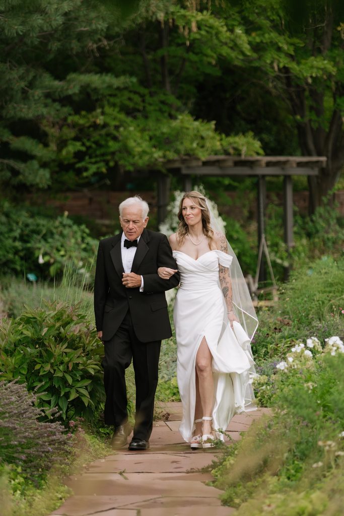 Bride and bride's dad walking down the isle at Red Butte Gardens.